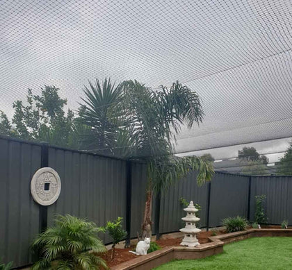 A whole backyard covered overhead with cat netting